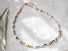 Freshwater pearl necklace with striped beads is colorful and cute. In this beaded necklace, I have paired white genuine freshwater pearls with colorful glass seed beads. Lovely piece that adds color to any outfit!  The beading wire I use is high-quality stainless steel, composed of multiple twisted tiny wires that are nylon coated to protect the beads. The metal parts of this necklace are gold-plated/stainless steel. Also available silver-plated, just send me a message! The length of this neckla White Pearl Necklace With Colorful Beads As Gift, Summer White Beaded Necklaces With Spacer Beads, Handmade Multicolor Pearl Necklace For Summer, Multicolor Pearl Necklace With Colorful Beads For Summer, Colorful Beads Pearl Necklace For Summer, Summer Pearl Beads As Gift, Summer Gift Pearl Necklace With Colorful Beads, Summer Pearl Beads As Gifts, Multicolor Pearl Necklace With Letter Beads For Gift