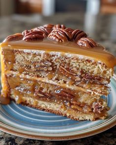 a piece of cake with pecans on top is sitting on a blue and white plate