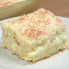 a close up of a piece of cake on a plate with a pan in the background