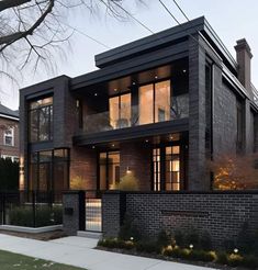 a large brick house with lots of windows on the top floor and two stories above it