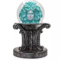 a snow globe with a woman's face in it on top of a stand