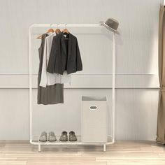 a clothes rack with two coats and shoes on it