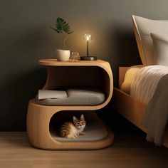 a cat sitting in the corner of a bed next to a night stand