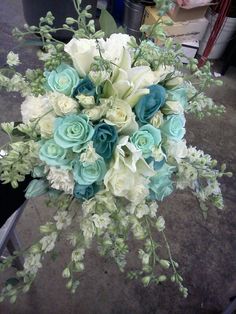 a bridal bouquet with blue and white flowers