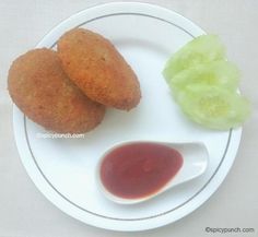 two fried food items on a plate with ketchup