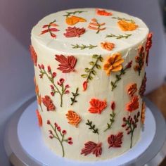 a white cake with orange and red flowers on it