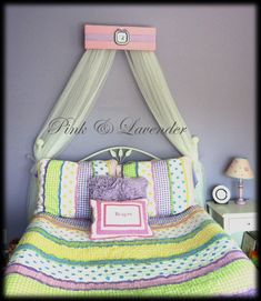 a bed with a canopy over it and pillows on top of the bedspread