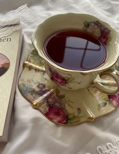 a cup of tea next to a book