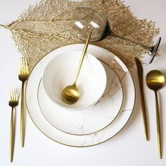 a white plate topped with two golden spoons