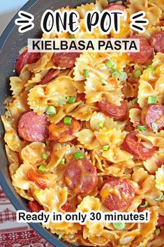 one pot kielbasa pasta in a skillet with text overlay that reads, one pot kielbasa