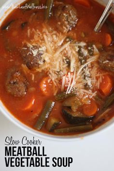 a white bowl filled with meatball vegetable soup