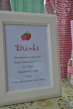 a strawberry lemonade drink recipe is displayed in a frame on a table with strawberries