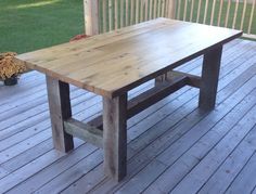 a wooden table sitting on top of a wooden deck