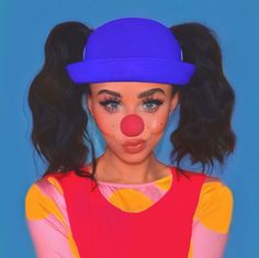 a woman wearing a clown nose and wig in front of a blue background with her hair pulled back