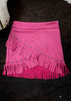 This skirt is giving us rhinestone cowgirl vibes! The asymmetric hem is adorned with fringe and silver studs. This skirt is finished with a invisible zipper on the hip. Cowgirl Vibes, Suede Fringe Skirt, Rhinestone Cowgirl, Romper And Jacket, Fringe Skirt, Suede Fringe, End Of Season Sale, Blazer With Jeans, Pink Suede