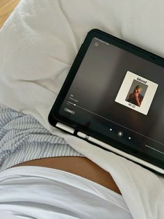 an open laptop computer sitting on top of a person's stomach, with the screen turned off