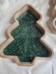 a wooden tray with a green christmas tree on it