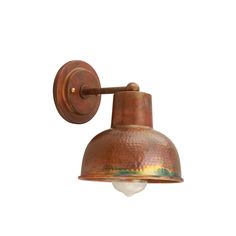 an old fashioned copper wall light with a white background