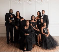 a group of people in formal wear posing for a photo