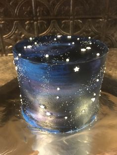 a blue candle with white stars on it