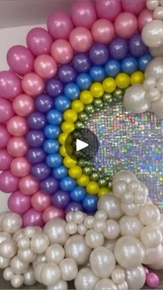 a rainbow made out of balloons in a room