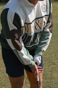 Tee time attire. Our classic fleece style sweatshirt with a ribbed collar quarter zip. Retro stripes of greens, butter yellow, and white frame the sweatshirt and feature embroidered details across chest with dark leather elbow patches. GOLF & SEA embroidered design across chest Yellow the Label script ribbon across chest Dark leather elbow patches Embroidered Yellow Yacht crest in green Thick ribbed trim along wrists, collar, and waistband Soft, fuzzy interior 52% cotton, 48% polyester Recommend Sporty Green Fleece Sweater, Green Half-zip Sweatshirt For Streetwear, Sporty Tops For Golf In Fall, Sporty Golf Tops For Fall, Green Fall Sports Sweater, Sporty White Long Sleeve Polo Sweater, White Sporty Polo Sweater For Fall, Sporty White Polo Sweater For Fall, Sporty Crew Neck Polo Sweater