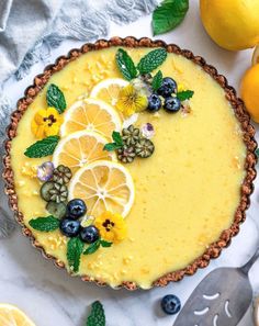 a pie with lemons and blueberries on top