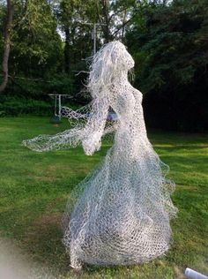 a woman is standing in the grass with her arms spread out and she has long white hair