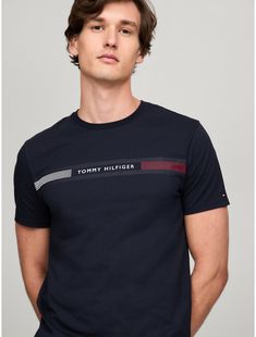 Tommy Hilfiger men's T-shirt. Made from lightweight cotton jersey, known for its breathability and stretch, our comfortable crewneck tee is cut in an easy fit and finished with our Tommy Stripe graphic.  Material: 100% Cotton. Modern Crew Neck T-shirt With Branding, Tommy Hilfiger Sporty T-shirt With Graphic Print, Tommy Hilfiger Sporty Graphic Print T-shirt, Tommy Hilfiger Graphic Tee For Summer, Tommy Hilfiger Summer Graphic Tee, Tommy Hilfiger Graphic Print Crew Neck T-shirt, Tommy Hilfiger Crew Neck T-shirt With Graphic Print, Tommy Hilfiger Blue T-shirt With Letter Print, Blue Tommy Hilfiger T-shirt With Letter Print