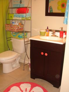 a bathroom with a toilet, sink and shelves on the wall in it's corner