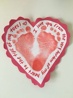 a hand and foot print in the shape of a heart with words written on it