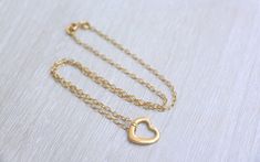 "14K Gold filled cable chain holding a sweet heart charm. Super cool dainty heart jewelry gift for her. Love / Friendship charm for a dear loved one gift. Shaped heart served to a loved one. Perfect little shiny gift for a birthday, graduation, inspirational or just for an everyday wear. Simple yet beautiful necklace jewelry you will Love to wear or give as present! ◆ DETAILS Chain: 14K Gold Filled Cable Chain Pendant: Quality 2 micron thick gold plated heart Pendant measures: 14.7mm X 13.7mm (= Dainty Heart Necklace With Cable Chain, Dainty Heart Necklace With Cable Chain For Gift, Heart Necklace With Cable Chain For Anniversary, Dainty Heart Necklace With Cable Chain For Anniversary, Anniversary Heart Necklace With Cable Chain, Heart Necklace Gold, Gold Heart Pendant, Heart Charm Necklace, Heart Choker