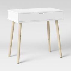 a white desk with wooden legs and drawers