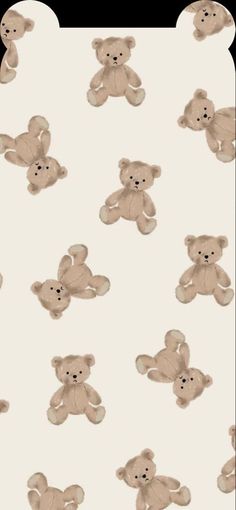 a group of teddy bears sitting next to each other on a white surface with black dots