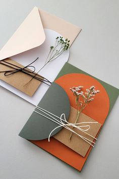 two greeting cards, one with a flower and the other with a bow on it