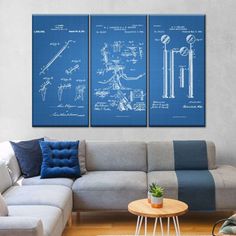 three blueprinted wall art pieces in a living room