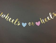 a banner that says wishes or needs hanging from a string with hearts and glitter on it