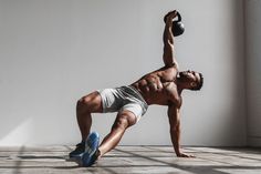 a man is doing push ups with a kettle