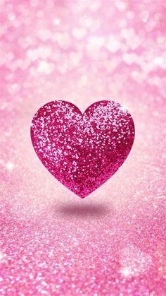 a pink glitter heart on a pink background