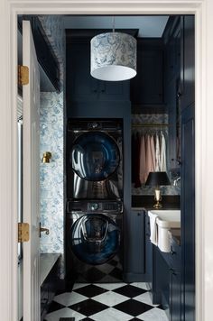 a black and white checkered floor in a laundry room with washer and dryer