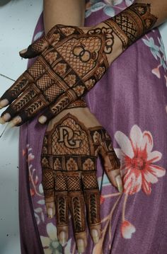 two hands with henna designs on them