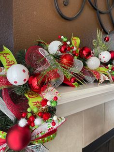 a mantle decorated with christmas decorations and ornaments