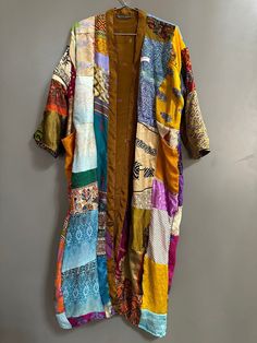 A gorgeous and stunning patchwork silk kimono that is sure to brighten up your day. perfect for any occasion: casual or an event, weekend lounging, resort wear or even as a coat/jacket. Silk kimono robes are perfect for lounging around the home or spa. Use our silk robe as a cover up on the beach or after a dip in the pool. Add a luxery, boho feel to your bridal shower. Versatile, soft and luxurious, our 100% silk kimono are well patched. The patchwork silk robe features 3/4th sleeves, a waist t Spring Beach Kimono With Patchwork, Multicolor Silk Beachwear Kimono, Multicolor Silk Kimono For Beachwear, Bohemian Multicolor Patterned Kimono, Bohemian Patterned Multicolor Kimono, Multicolor Kimono For The Beach, Multicolor Kimono With Colorful Pattern For Beach, Multicolor Patchwork Kimono For Spring, Multicolor Cotton Kimono For Festival