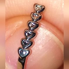 a close up of a person's nose with a diamond ring on top of it