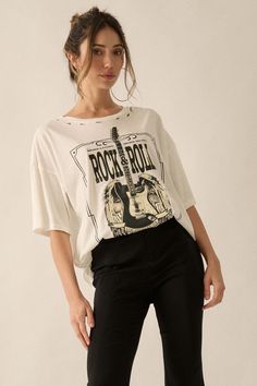 Distressed, garment washed graphic t-shirt. Torn and distressed detailing at neckline, cuffs, and hem. Vintage-style guitar with angel wings graphic print with "Rock & Roll" and other text. Round neckline. Short sleeves. Dropped shoulder. Oversized fit. 100% Cotton. Imported top designed and printed in LA. Model wears size S. Angel Guitar, Angel Wings Graphic, Distressed Graphic Tee, Rock Roll, Angel Wings, Oversized Fits, Rock And Roll, Round Neckline, Graphic Prints