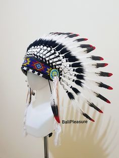 White Black & Red Feather Indian Headdress This Headdress is 100% handmade from Feathers and Leather. * Head circumference: 59 centimeters / 23 inches * Length : Short * Beads color and pattern may vary each headdress WHY US? * 100% Handmade and Eco Friendly Product * Finest Quality - Each item will go through a Quality Control process before shipping. * No Markup Price * Every purchase supports Balinese Artisans - All Artisans will keep on following their passions while providing for their Lolíta Headdress, Buffalo Headdress, Indian Feather Headdress, Feathered Headdress, Indian Hat, Eco Friendly Product, Indian Headdress Metal Art, Native American Feathers, Festival Costume