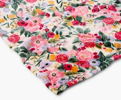 an image of a flowered fabric on a white background with red, yellow and pink flowers