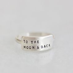 "The Cherished inspiRING makes for the perfect everyday ring that features your favorite little reminder. Designed to be the little sister to the wide inspiRING, this ring will be one you cherish for years to come. Letters are individually stamped by hand, making each ring one of a kind. The message is left justified in our signature teeny-tiny upper case block font. Choose one of our messages https://www.etsy.com/listing/896792268 or create your own. details + message plate measures 5/8\" wide Minimalist Engraved Midi Rings For Everyday, Dainty Everyday Adjustable Engraved Ring, Dainty Adjustable Engraved Ring For Everyday, Minimalist Everyday Hand Stamped Rings, Everyday Meaningful Hand Stamped Stackable Rings, Everyday Minimalist Hand Stamped Rings, Minimalist Hand Stamped Rings For Everyday, Inspirational Adjustable Sterling Silver Rings, Adjustable Inspirational Sterling Silver Rings