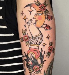 a woman's arm with tattoos on it and a half moon above her head