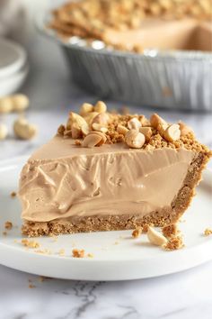 a piece of pie with peanut butter frosting on a white plate next to another pie